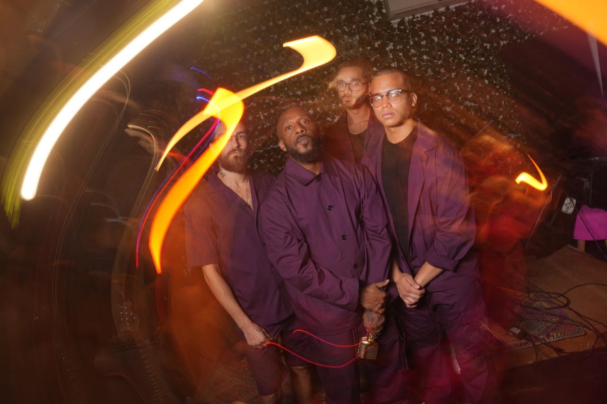 The band lit by streaks of coloured light